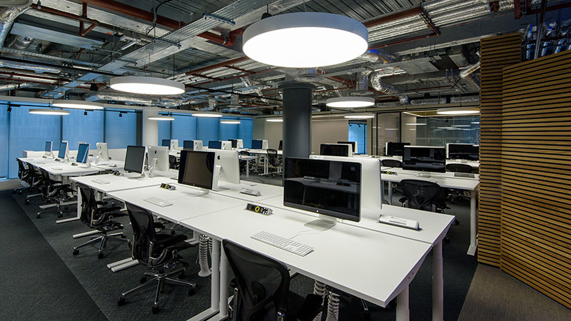 An office space with multiple computer stations setup.