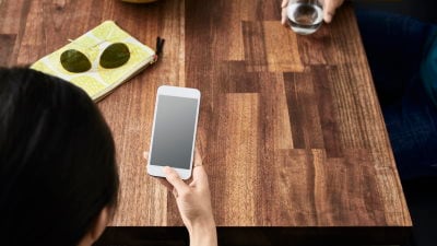 Woman at table using mobile